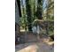 View of the backyard with a small shed covered in greenery and a chain link fence at 865 Cherrydale Ln, Woodstock, GA 30189