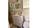 Modest bathroom featuring a vanity with a framed mirror and a shower with a patterned curtain at 865 Cherrydale Ln, Woodstock, GA 30189