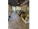 Enclosed patio with multiple ceiling fans, furniture, and an exercise machine at 865 Cherrydale Ln, Woodstock, GA 30189