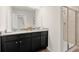 Modern bathroom with double vanity, granite countertop, and a glass-enclosed walk-in shower at 936 Elwood St, Dacula, GA 30019