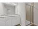 Bathroom with double sinks, granite counters, tile backsplash, and a glass-enclosed tile shower at 936 Elwood St, Dacula, GA 30019