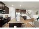 Modern kitchen features stainless steel appliances, granite countertops, and dark wood cabinets at 936 Elwood St, Dacula, GA 30019