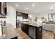 Beautiful kitchen with granite countertops, stainless steel appliances, and dark wood cabinetry overlooking the living area at 936 Elwood St, Dacula, GA 30019