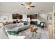 Stylishly furnished living room featuring wood floors, a curved couch, and an open concept kitchen at 936 Elwood St, Dacula, GA 30019