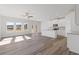 Bright open-concept living room with hardwood floors, large windows, and access to the back patio at 936 Elwood St, Dacula, GA 30019