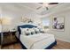 Luxurious primary bedroom with tray ceiling, plush carpeting, and ample natural light from large windows at 936 Elwood St, Dacula, GA 30019