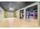A large basement space with a dark tile ceiling and decorative pillars at 206 Towler Dr, Loganville, GA 30052
