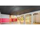 Spacious basement with a dark tile ceiling, a bar area, and decorative walls at 206 Towler Dr, Loganville, GA 30052