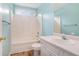 Bathroom featuring a shower/tub combo, blue walls and a single sink vanity at 206 Towler Dr, Loganville, GA 30052