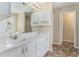 Bathroom featuring double sinks, white cabinetry, and a door leading to the water closet at 206 Towler Dr, Loganville, GA 30052