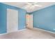 Bedroom with blue walls, a ceiling fan and two doors leading to other rooms at 206 Towler Dr, Loganville, GA 30052