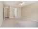 Bedroom with neutral walls features a ceiling fan and two doorways at 206 Towler Dr, Loganville, GA 30052