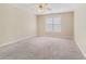 Neutral bedroom features a ceiling fan and a window letting in natural light at 206 Towler Dr, Loganville, GA 30052