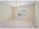 Bedroom with neutral walls features a ceiling fan and a window letting in natural light at 206 Towler Dr, Loganville, GA 30052