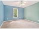 Bedroom with blue and green walls with a ceiling fan and window letting in natural light at 206 Towler Dr, Loganville, GA 30052