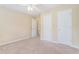 Bedroom with neutral walls features a ceiling fan and two doors leading to other rooms at 206 Towler Dr, Loganville, GA 30052