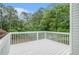 White wooden deck overlooking a lush backyard surrounded by mature trees at 206 Towler Dr, Loganville, GA 30052