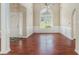 Inviting dining room featuring hardwood floors, wainscoting, and an arched window at 206 Towler Dr, Loganville, GA 30052