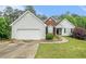 Charming single Gathering home featuring vinyl siding, brick accents, and a well manicured lawn at 206 Towler Dr, Loganville, GA 30052
