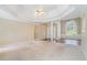 Expansive living room featuring a trey ceiling, lots of natural light, and hardwood floors at 206 Towler Dr, Loganville, GA 30052