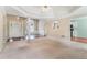 Open-concept living room with natural light, elegant columns, and hardwood floors at 206 Towler Dr, Loganville, GA 30052