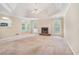 Inviting living room featuring a tray ceiling, a ceiling fan, and a cozy fireplace at 206 Towler Dr, Loganville, GA 30052