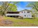White, two-story house with a screened-in porch and backyard at 2617 Peggy Sue Ln, Morrow, GA 30260