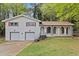 Charming two-story brick home featuring an attached two-car garage and inviting front porch with decorative columns at 2617 Peggy Sue Ln, Morrow, GA 30260