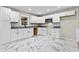 Modern kitchen boasts white cabinets and stone countertops at 2617 Peggy Sue Ln, Morrow, GA 30260