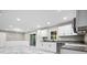 Bright kitchen featuring white cabinets, stone countertops, and stainless steel appliances at 2617 Peggy Sue Ln, Morrow, GA 30260