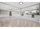 Open-concept living space with wood floors, recessed lighting, and a combination of a living area and a modern kitchen at 2617 Peggy Sue Ln, Morrow, GA 30260