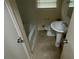 View of a standard bathroom featuring a pedestal sink, toilet, and tub/shower combination at 6344 Fitzgerald Ln, Austell, GA 30168