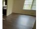 Bright living room featuring hardwood floors, a large window, and access to other parts of the home at 6344 Fitzgerald Ln, Austell, GA 30168