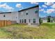 Spacious backyard featuring a concrete patio and a partial fence for privacy, offering outdoor living at 1431 Winding Ridge Trl, Buford, GA 30548