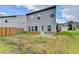 Spacious backyard featuring a concrete patio and a partial fence for privacy, offering outdoor living at 1431 Winding Ridge Trl, Buford, GA 30548