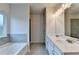 Bathroom features a double sink vanity, soaking tub, and a separate shower at 1431 Winding Ridge Trl, Buford, GA 30548