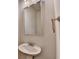 Bathroom with pedestal sink, chrome fixtures, and a large vanity mirror at 1431 Winding Ridge Trl, Buford, GA 30548