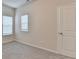 Neutral bedroom with plush carpet and two windows at 1431 Winding Ridge Trl, Buford, GA 30548