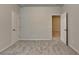 Neutral bedroom with carpet and two doors at 1431 Winding Ridge Trl, Buford, GA 30548