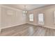 Well-lit dining room featuring a modern chandelier, light neutral walls, and light wood flooring at 1431 Winding Ridge Trl, Buford, GA 30548