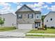 Charming two-story home with a gray brick facade, attached garage, and well-maintained landscaping at 1431 Winding Ridge Trl, Buford, GA 30548
