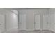 Hallway with multiple doors and gray carpet at 1431 Winding Ridge Trl, Buford, GA 30548