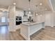 Bright and open kitchen with stainless steel appliances, granite countertops, and a large center island at 1431 Winding Ridge Trl, Buford, GA 30548