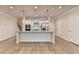 Island kitchen featuring stainless appliances, granite counters, and hardwood floors at 1431 Winding Ridge Trl, Buford, GA 30548