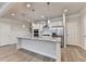 Bright kitchen features a large island with granite countertops and stainless steel appliances at 1431 Winding Ridge Trl, Buford, GA 30548