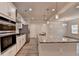 Well-lit kitchen showcases stainless appliances, granite counters, and an extended island with a sink at 1431 Winding Ridge Trl, Buford, GA 30548