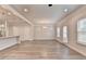 Bright, open living room with hardwood floors, neutral walls, and modern lighting fixtures at 1431 Winding Ridge Trl, Buford, GA 30548