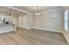 Open concept kitchen, dining, and living room with hardwood flooring and neutral walls at 1431 Winding Ridge Trl, Buford, GA 30548