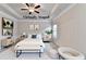 Virtually staged bedroom with tray ceilings, ceiling fan, and coordinated decor at 1431 Winding Ridge Trl, Buford, GA 30548