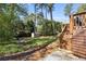 A serene backyard featuring a lush lawn, wooden deck, storage shed, and inviting fire pit area at 200 Heaton Park Dr, Decatur, GA 30030